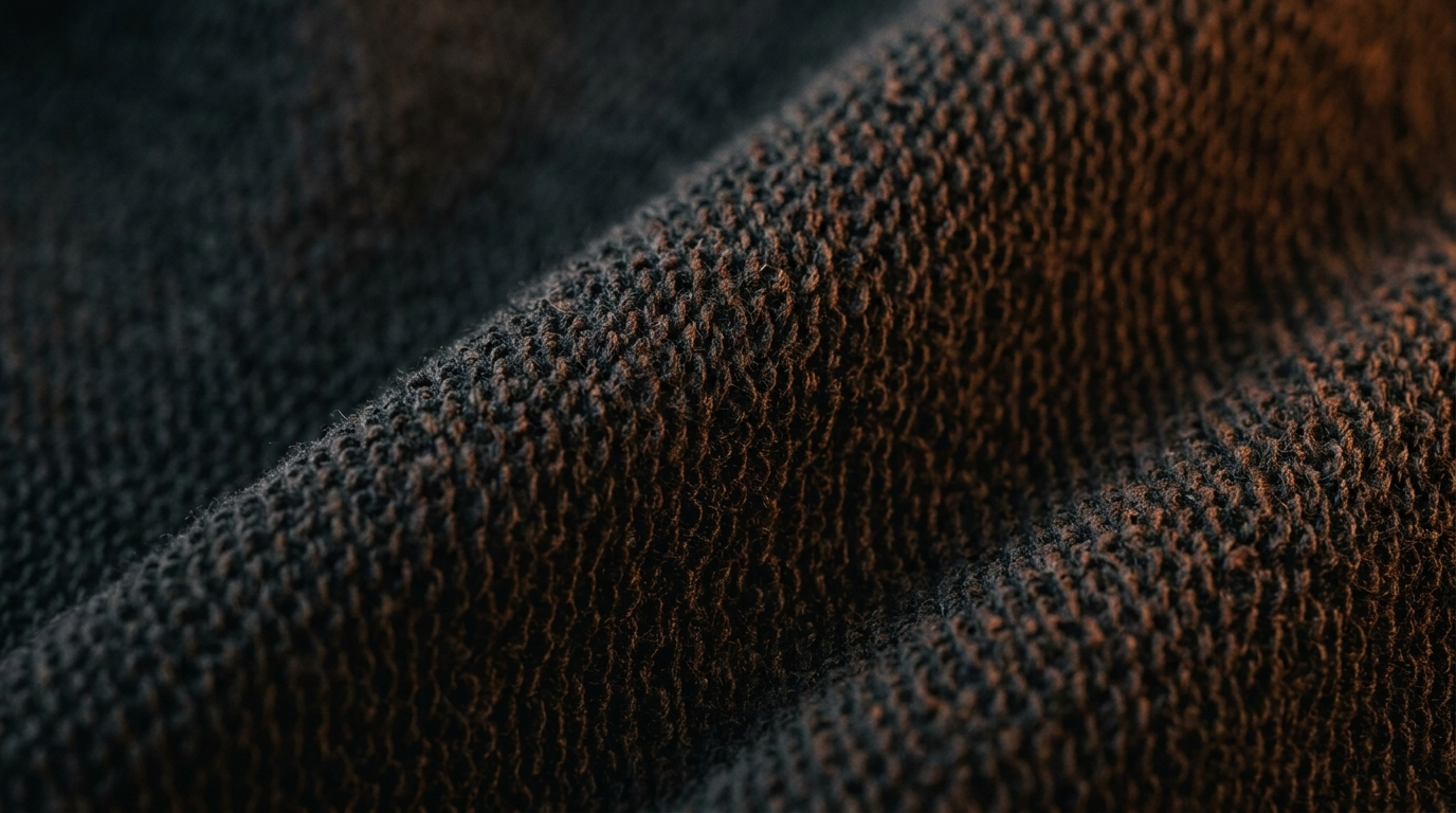 Macro texture close-up of heavyweight cotton French terry fabric showing dense loopback knit construction