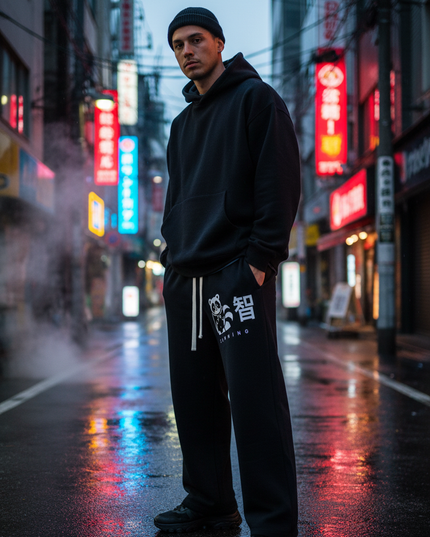 Model in the Shinsei wide-leg sweatpants on a rainy neon street